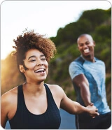 happy couple smiling and laughing while on a run
